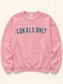 Lokals Only Crewneck flat lay showing patterned fabric applique with stitched edges